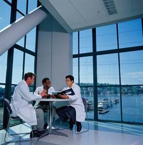 科学,通讯,讨论,研究,摄影_AA049520_Three research scientists in lab coats meeting at round table_创意图片_Getty Images China